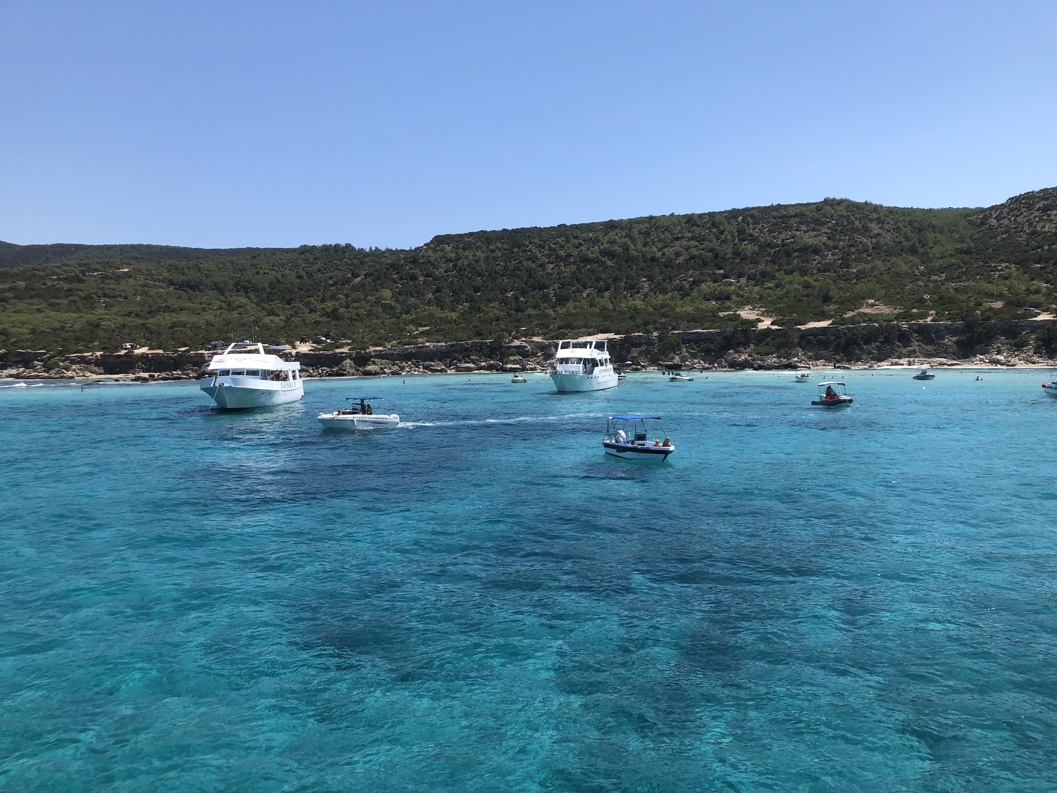 The Aquamarine water of Blue Lagoon is dotted with tour boats.jpg
